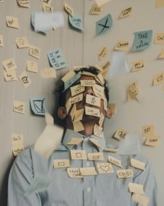 Man covered with Post It notes