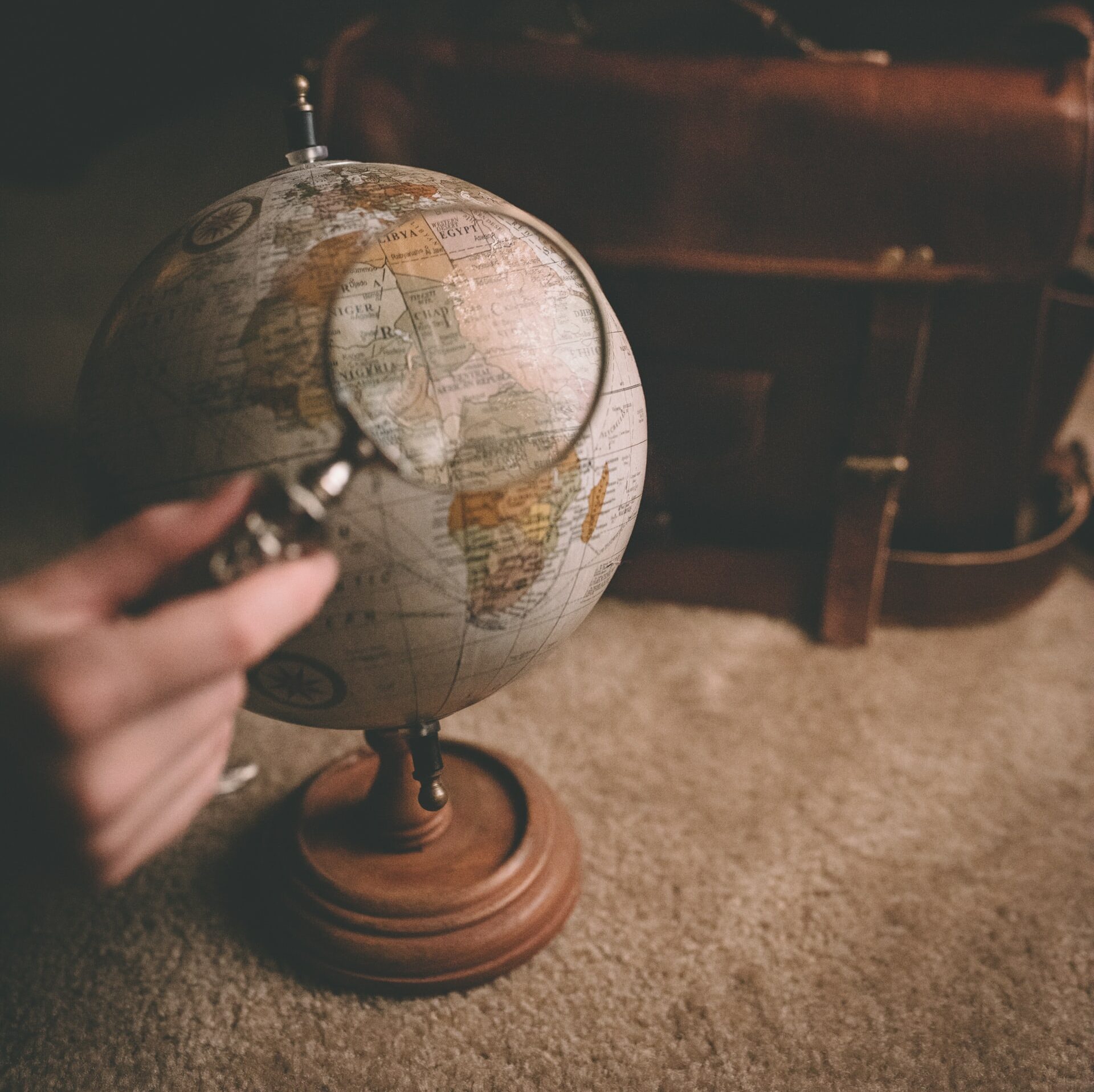 looking at a globe with a magnifying glass 