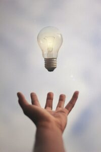 Hand tossing a lightbulb