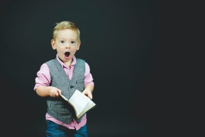 Boy singing from a hymn book